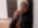 Naked Mistress on the floor smoking in a leather jacket
