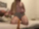 Shy girl in grey short sucking a dildo