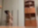 Pregnant in a bdsm mask beats herself on the tummy with a belt