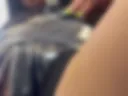 in a leather bodysuit with an unbuttoned fly showing her pussy