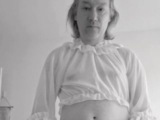 Again in a white translucent mini blouse with sparkles