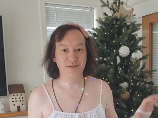 In a white top near the Christmas tree