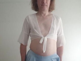 In a mini blouse, stockings and white panties pulled down