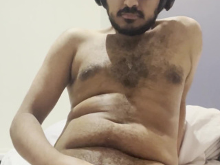 Stroking my dick while sitting on my bed